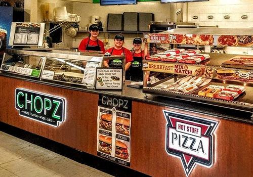 Chopz and Hot Stuff Pizza section of Timberline Sports-N-Convenience with three employees behind the counter
