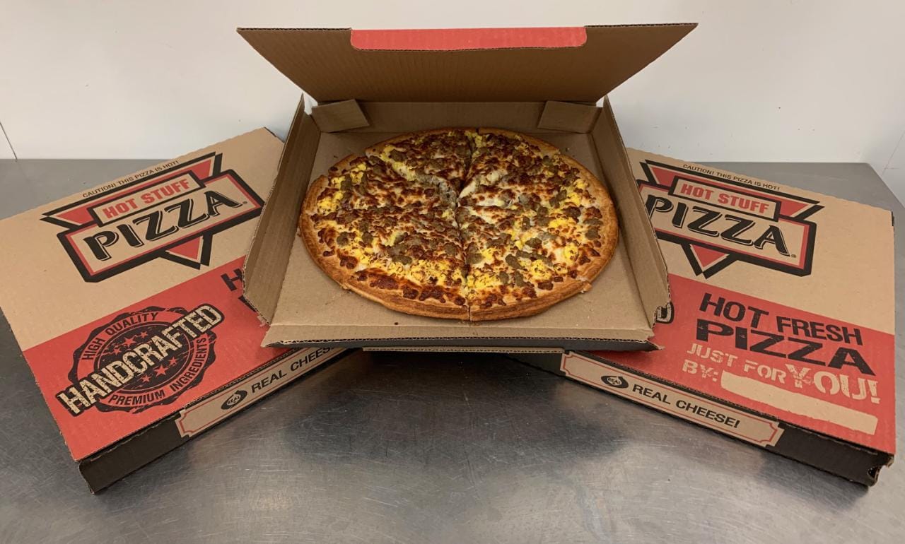 All meat Hot Stuff Pizza in open box on top of two other hot stuff pizza boxes offered at Timberline Sports-N-Convenience in Blackduck MN