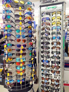 two racks of Sunglasses for sale at Timberline Sports-N-Convenience